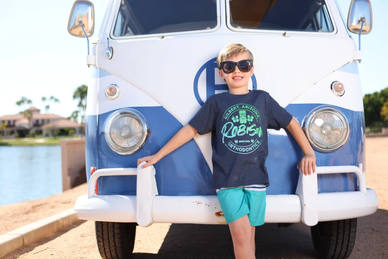 a boy in front of a van