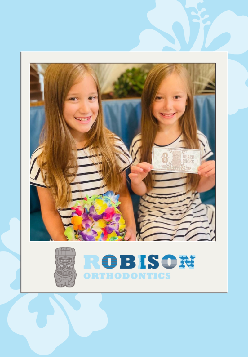 2 young girls holding a prize