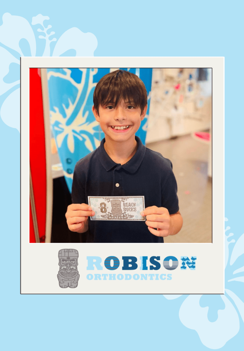 a boy holding a prize